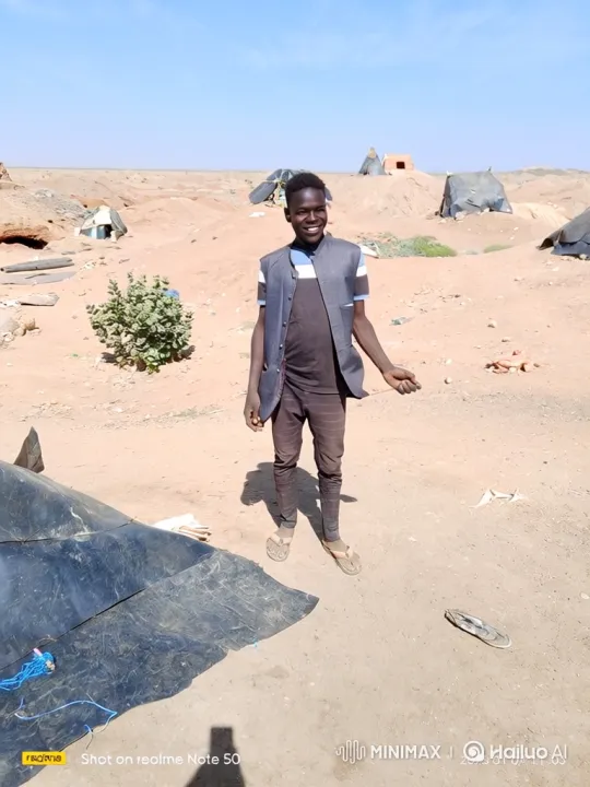 Young Black Man Smiles, Walks Through Desert Landscape – AI Generated Video | Hailuo AI