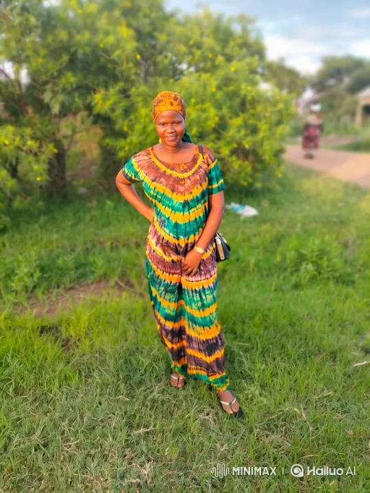 Woman in Vibrant Outfit Stands Gracefully in Breezy Field – AI Generated Video | Hailuo AI