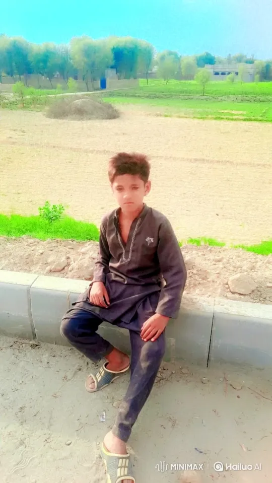 Young Boy Sitting Calmly on Rural Concrete Curbscape – AI Generated Video | Hailuo AI