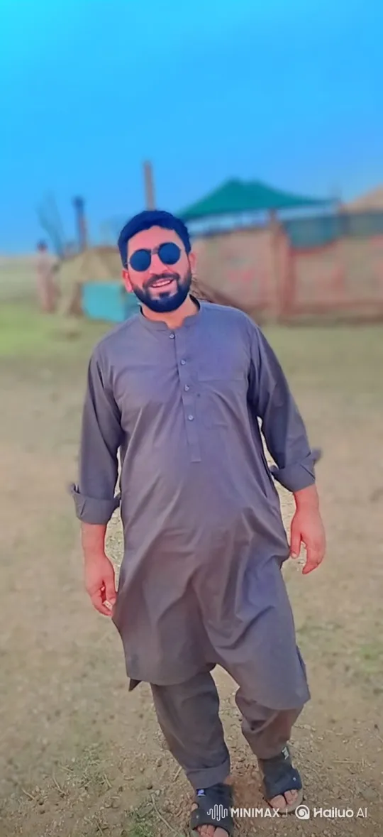 Man in Traditional Attire Smiles and Walks Forward – AI Generated Video | Hailuo AI