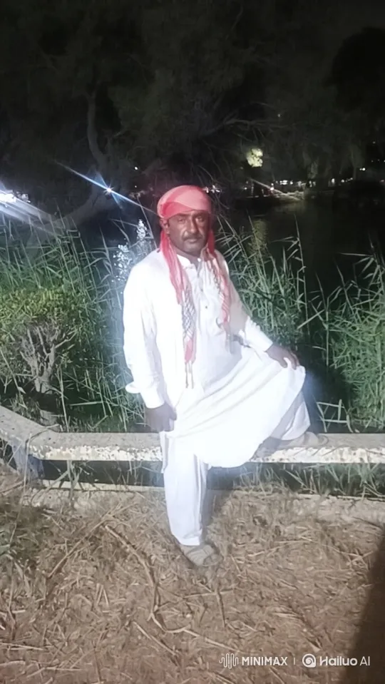 Man in White Tunic Walks Along Water at Night – AI Generated Video | Hailuo AI