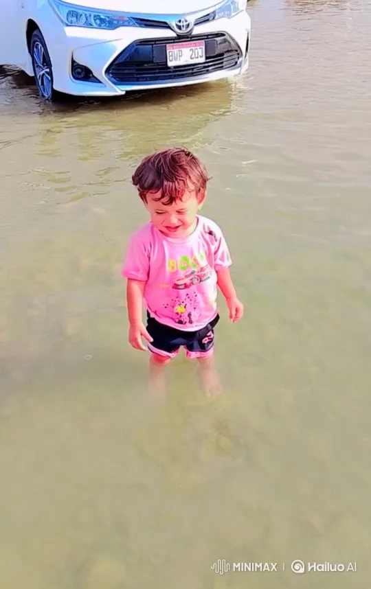 Boy enters car in shallow water, drives away – AI Generated Video | Hailuo AI