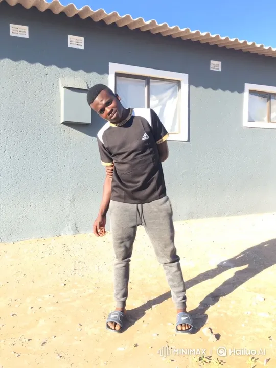 Young Man Stands in Relaxing Pose in Front of House – AI Generated Video | Hailuo AI