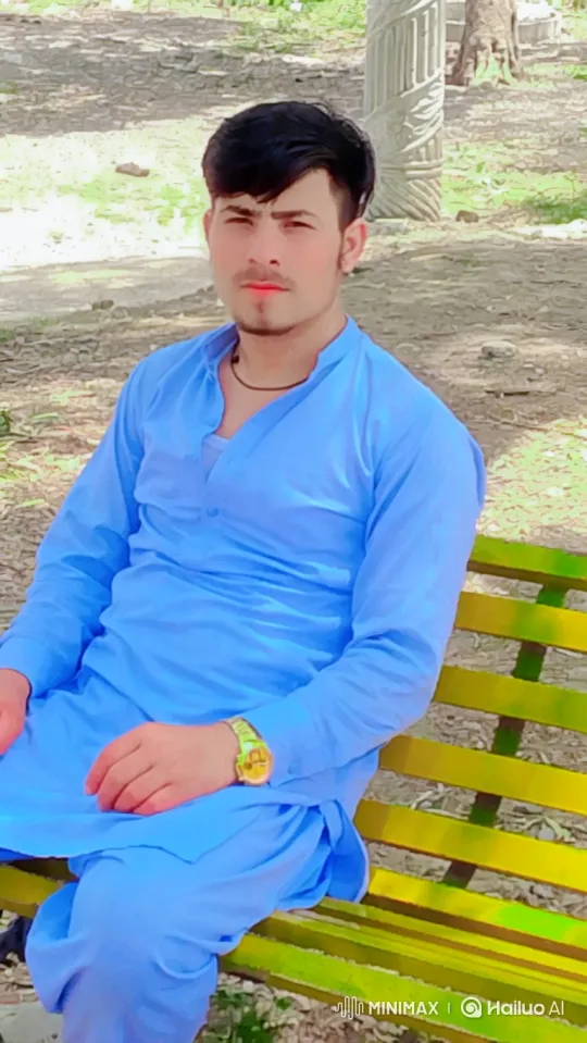 Young Man Smiles Gently on Park Bench – AI Generated Video | Hailuo AI