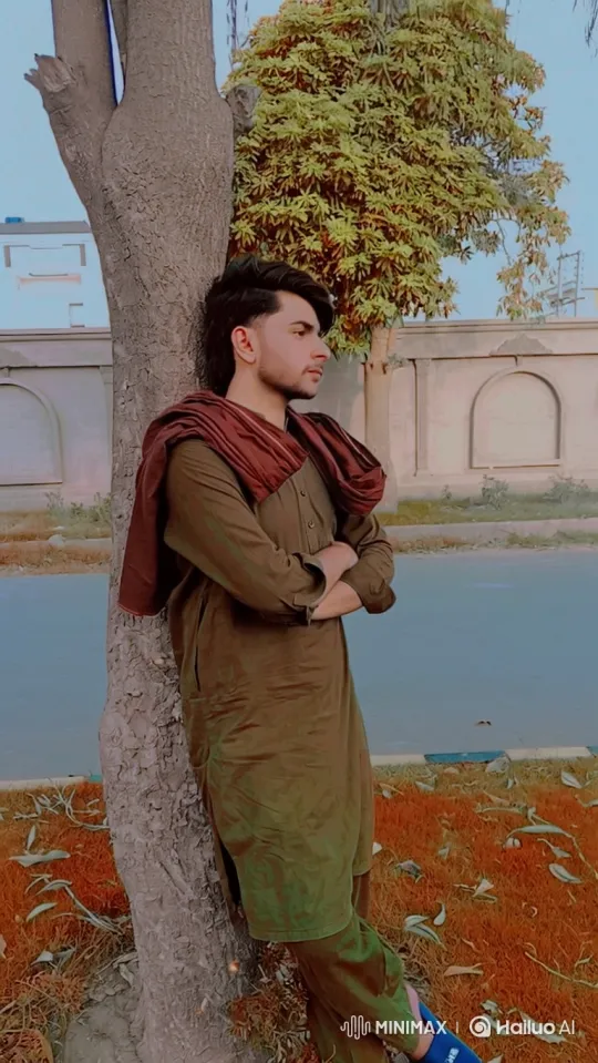 Young Man Contemplates by a Tree in Tranquil Setting – AI Generated Video | Hailuo AI