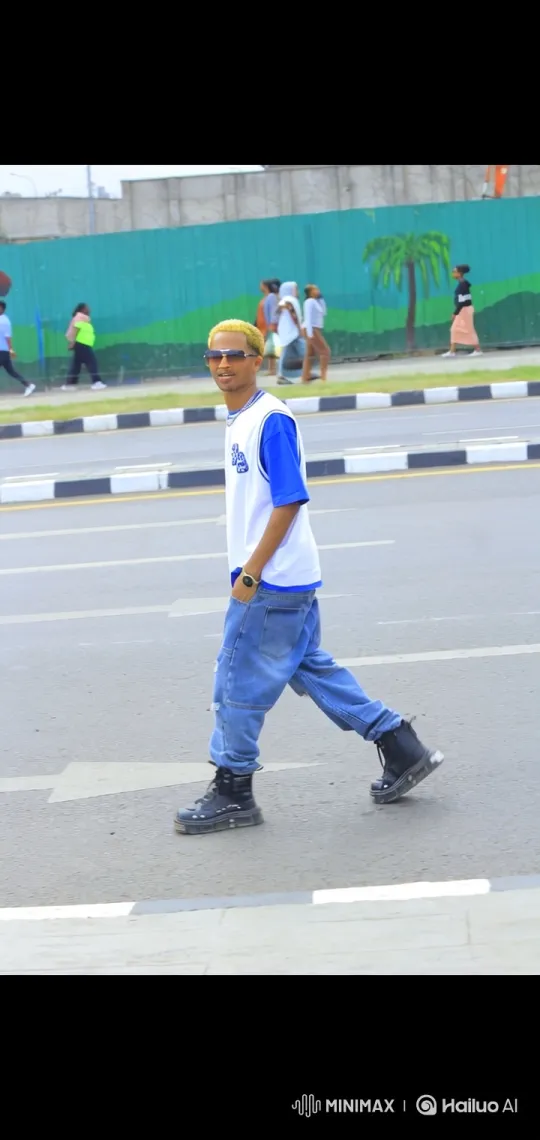 Young Man Walks Across Street in Urban Setting – AI Generated Video | Hailuo AI