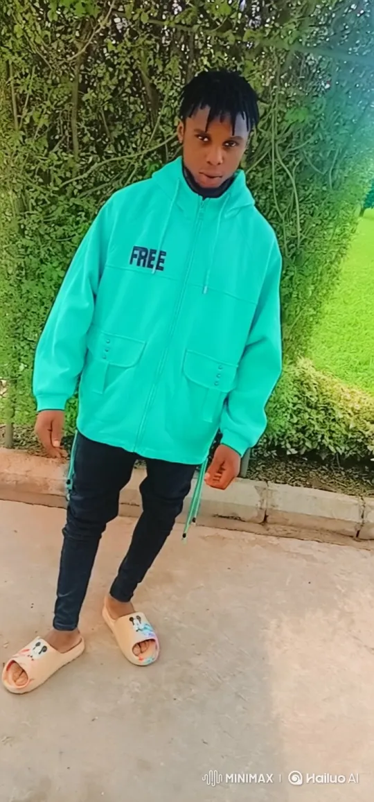 Young Man in Hoodie Walks Down Concrete Path – AI Generated Video | Hailuo AI