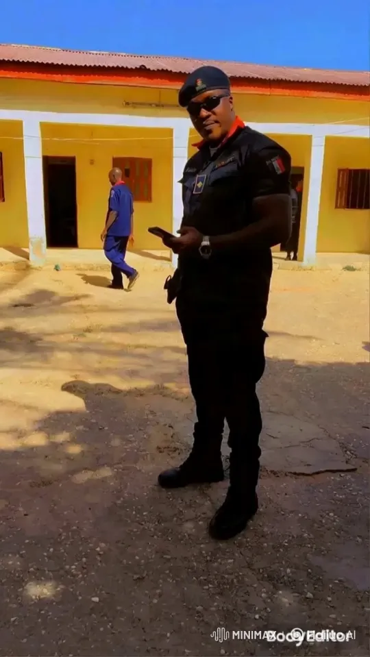 Man in Uniform Engages with Smartphone in Courtyard – AI Generated Video | Hailuo AI