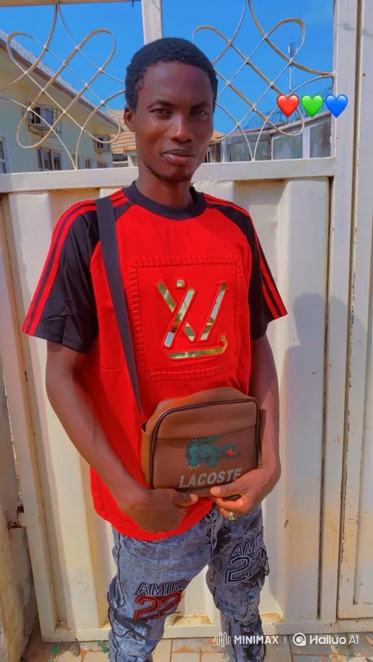 Young Man in Red Shirt in Front of Gate with Pulsing Heart Emojis – AI Generated Video | Hailuo AI