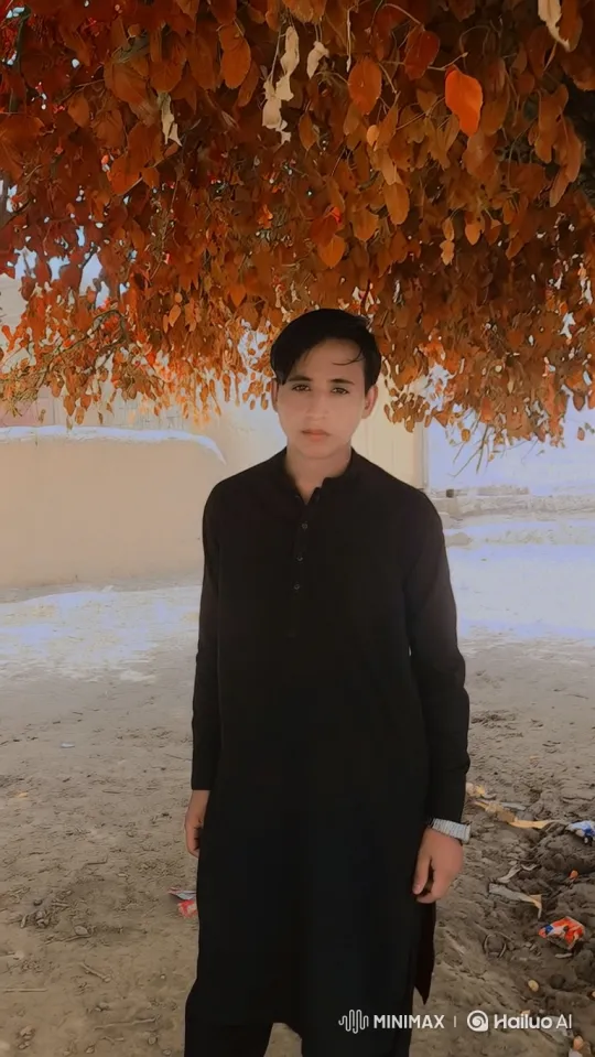 Young Man Smiles Under Swaying Autumn Leaves – AI Generated Video | Hailuo AI