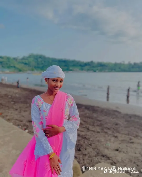 Young Woman on Beach Promenade with Flowing Scarf – AI Generated Video | Hailuo AI