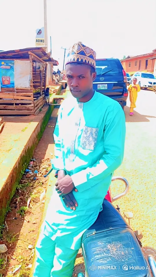 Man in Turquoise Suit Sits on Motorcycle, Stares Steadily at Camera – AI Generated Video | Hailuo AI