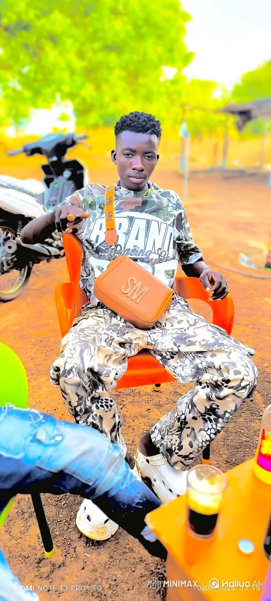 Stylish Man in Orange Chair: A Study in Confidence – AI Generated Video | Hailuo AI