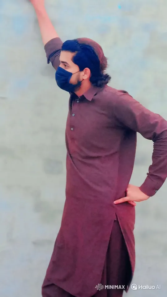 Young Man in Maroon Tunic Turns to Camera – AI Generated Video | Hailuo AI