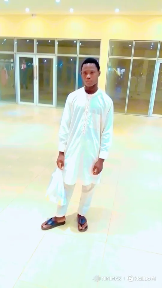 Young Man Observes and Steps in a Bright Hall – AI Generated Video | Hailuo AI