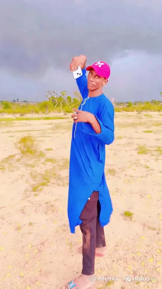 Vibrantly Dressed Man in Stormy Desert Taking Selfie – AI Generated Video | Hailuo AI