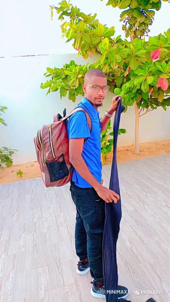 Young Man Folds Fabric, Secures It in Backpack – AI Generated Video | Hailuo AI