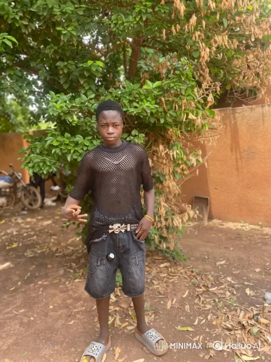 Young Man Poses Confidently in Dirt Yard – AI Generated Video | Hailuo AI