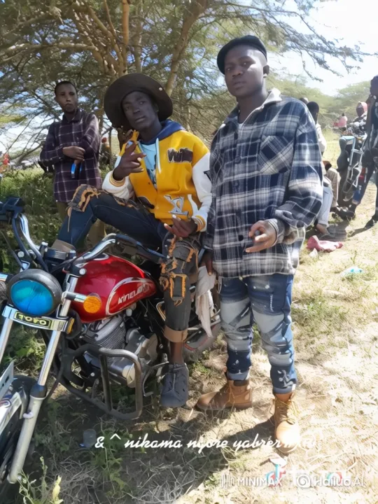 Three Friends Pose with Motorcycle in Arid Landscape – AI Generated Video | Hailuo AI