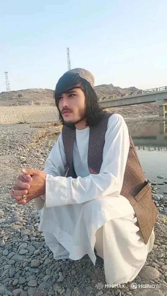 Young Man in Contemplation by a Tranquil River – AI Generated Video | Hailuo AI