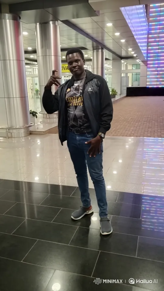 Young Man Walking Through Modern Hall with Tracking Camera – AI Generated Video | Hailuo AI