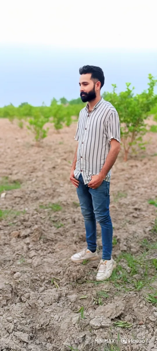 Young Man Reflects in a Tilled Field Amidst Saplings – AI Generated Video | Hailuo AI