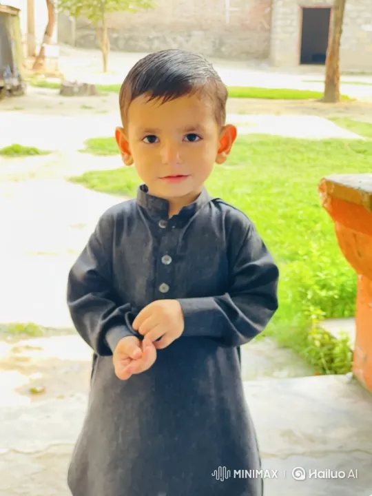 Boy Adjusts Sleeve, Smiles Peacefully – AI Generated Video | Hailuo AI
