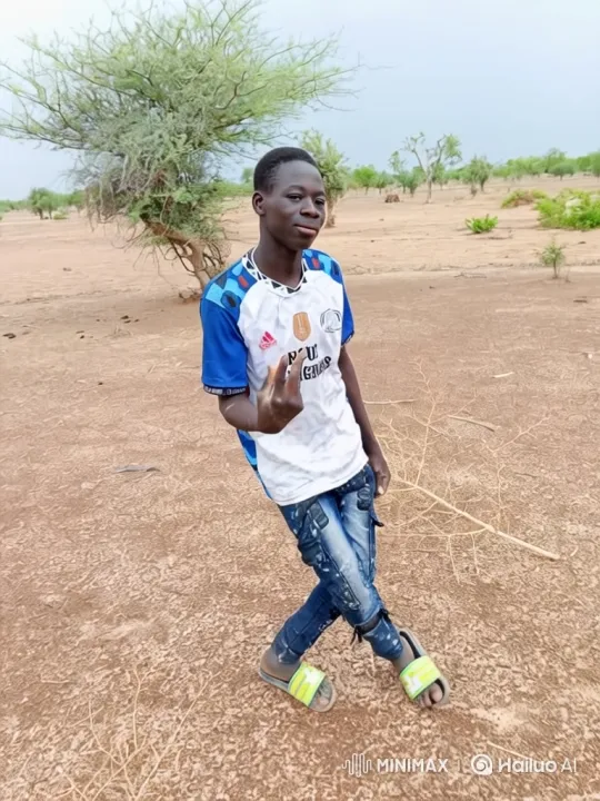 Young Man Prepares for a Journey in a Dry Field – AI Generated Video | Hailuo AI