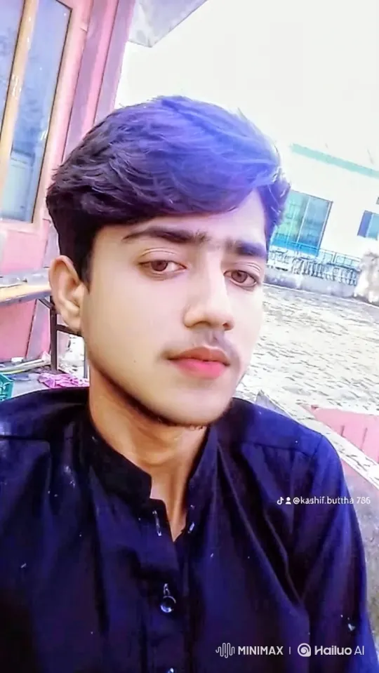 Young Man with Purple Hair Smiles Calmly at Camera – AI Generated Video | Hailuo AI