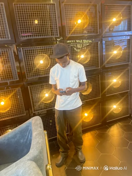 Young Man Obsessed with Smartphone in Stylish Room – AI Generated Video | Hailuo AI
