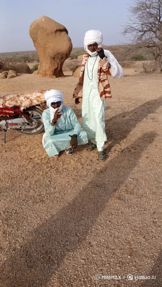 Two Men in Desert with Motorcycle and Rock Formation – AI Generated Video | Hailuo AI