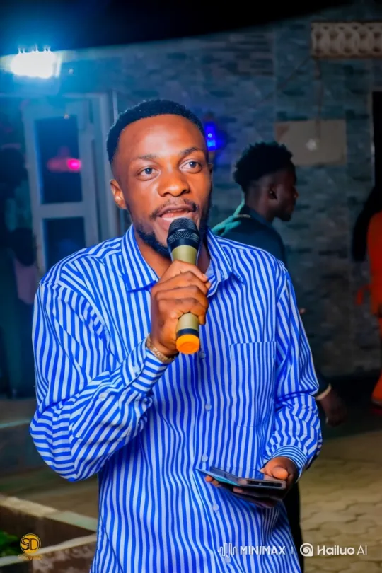 Young Black Man Performing with Microphone in Dimly Lit Space – AI Generated Video | Hailuo AI