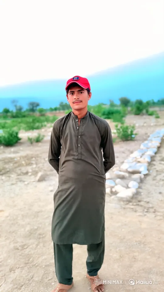 Young Man in Rural Landscape with Subtle Smiles – AI Generated Video | Hailuo AI