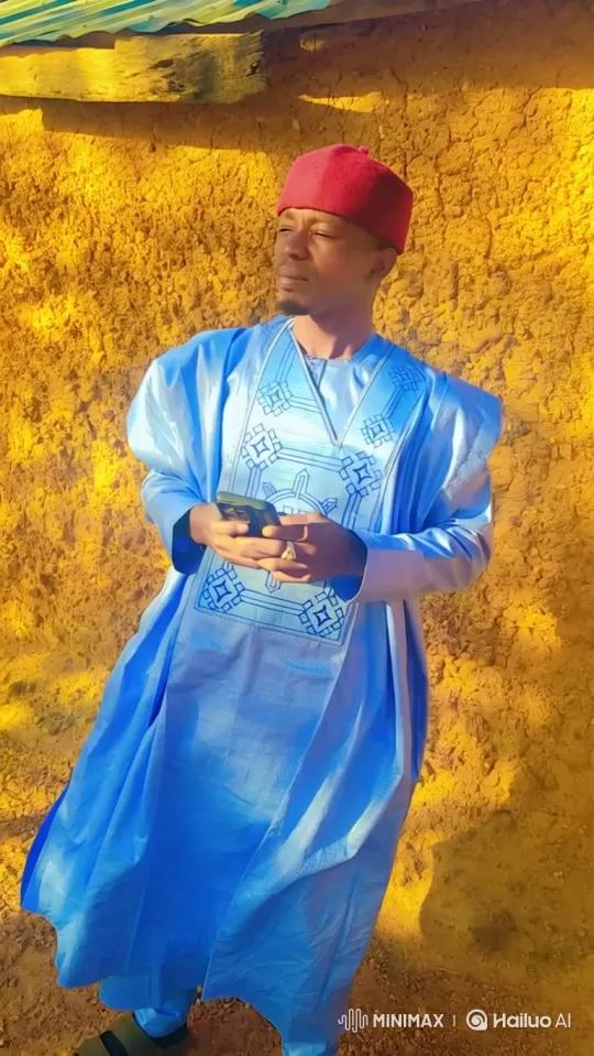 Man in Robe Uses Smartphone with Serene Expression – AI Generated Video | Hailuo AI