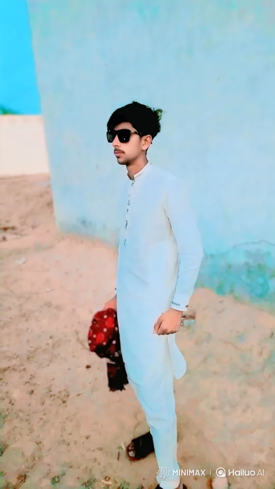 Young Man in White Attire Contemplates on Sandy Ground – AI Generated Video | Hailuo AI