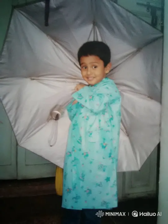 Young Boy in Raincoat Holds Umbrella with Joy – AI Generated Video | Hailuo AI