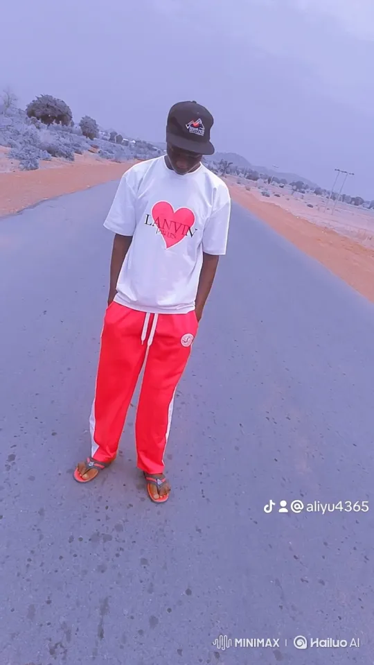 Young Man Ponders on a Desolate Road in Lavender-Tinted Landscape – AI Generated Video | Hailuo AI