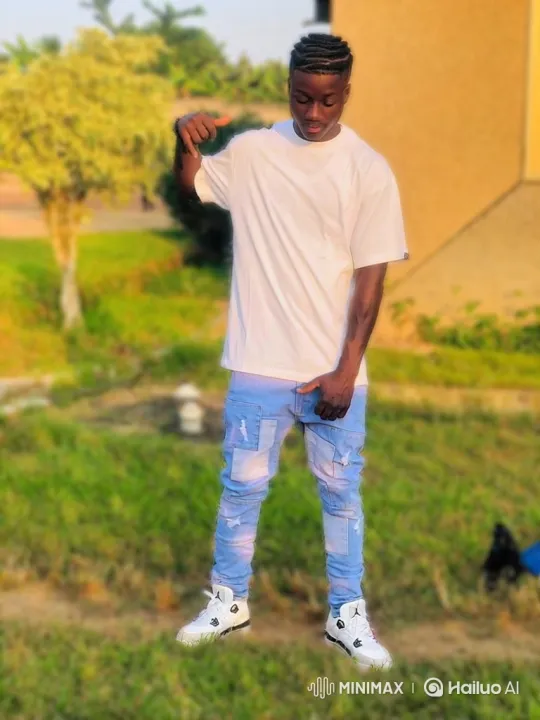 Young Man on Lawn: Golden Hour, Focused Stance – AI Generated Video | Hailuo AI