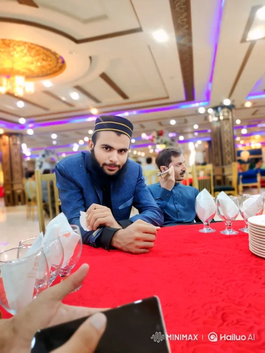 Young Man in Banquet Hall: Expansive Tracking and Rising Camera Shot – AI Generated Video | Hailuo AI