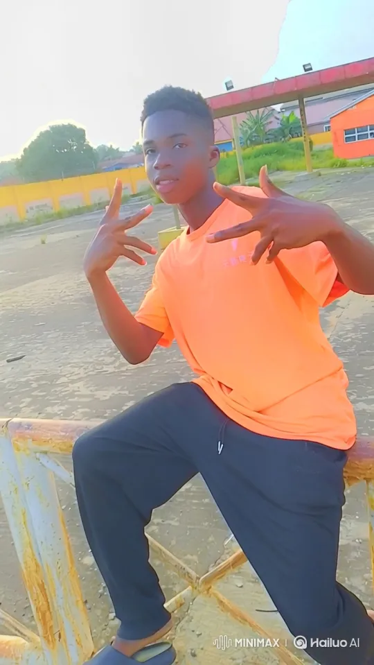 Young Man in Orange Shirt Maintains Confident Stance – AI Generated Video | Hailuo AI