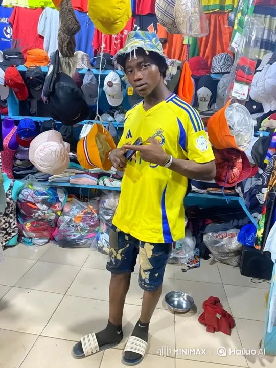 Young Man in Bright Clothing Stall - Video Shot Analysis – AI Generated Video | Hailuo AI