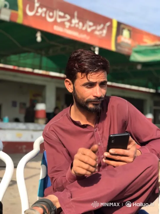 Man in Maroon Shirt Discusses on Smartphone – AI Generated Video | Hailuo AI