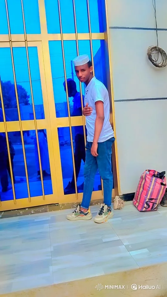 Young Man Poses Stylishly in Front of Modern Building – AI Generated Video | Hailuo AI