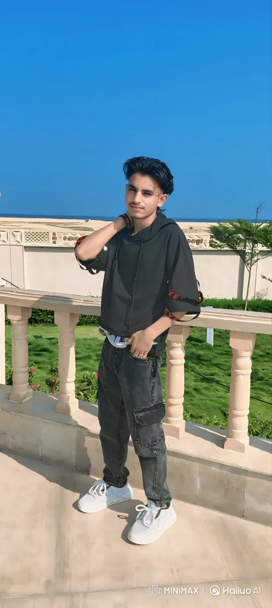 Young Man Poses Calmly on Terrace with Gentle Smile – AI Generated Video | Hailuo AI