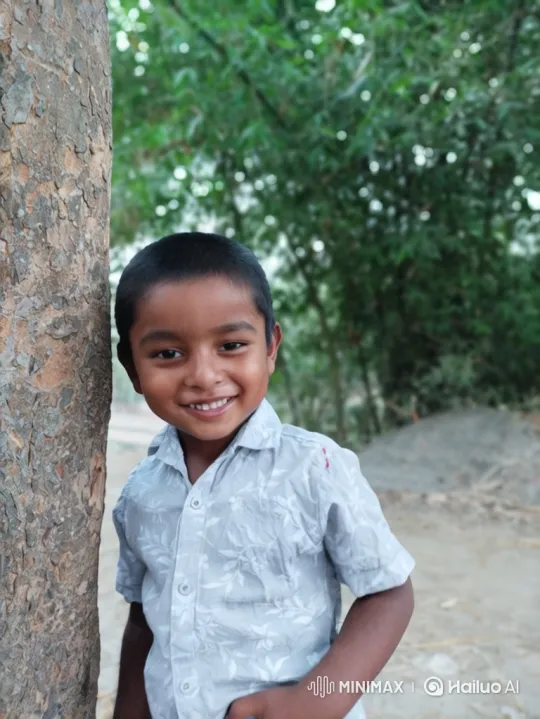 Boy Smiling by Tree with Closer Shot – AI Generated Video | Hailuo AI