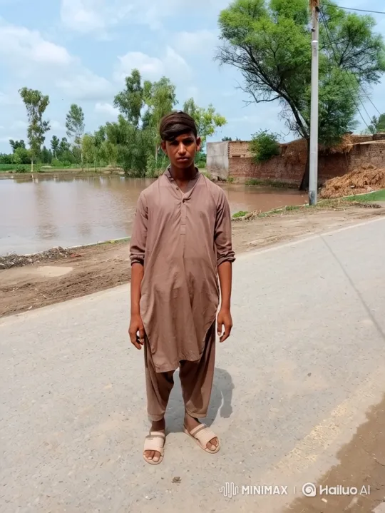 Young Man Reflects on Flooded Rural Landscape – AI Generated Video | Hailuo AI