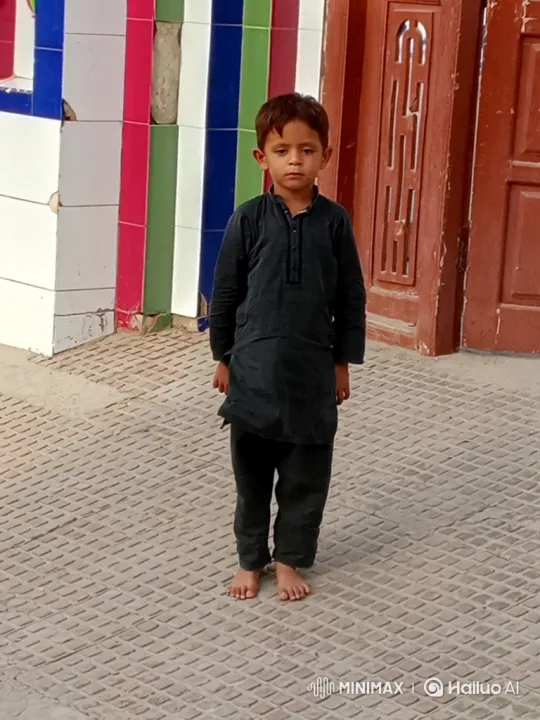 Young Boy in Black Stares Solemnly at Camera – AI Generated Video | Hailuo AI