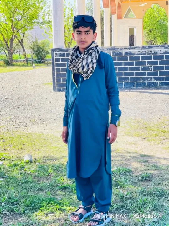 Young Boy in Teal Tunic Enjoying a Gentle Breeze – AI Generated Video | Hailuo AI