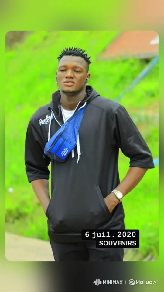 Contemplative Young Man in Grassy Slope Setting – AI Generated Video | Hailuo AI