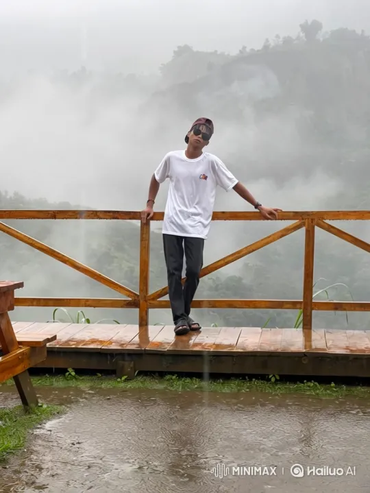 Young Man on Wet Deck Amidst Rain and Mist – AI Generated Video | Hailuo AI